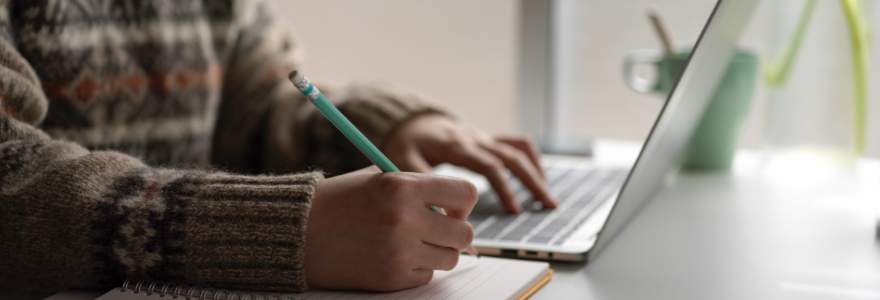 Student typing on laptop